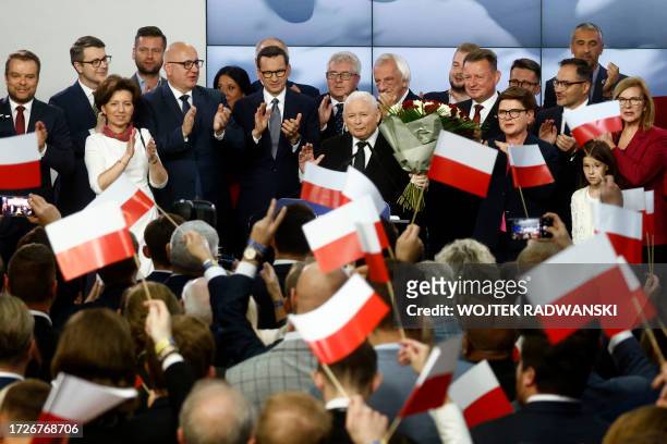 Polish Deputy Prime Minister and leader of the Law and Justice party party, Jaroslaw Kaczynski stands next to Polish Prime Minister Mateusz...