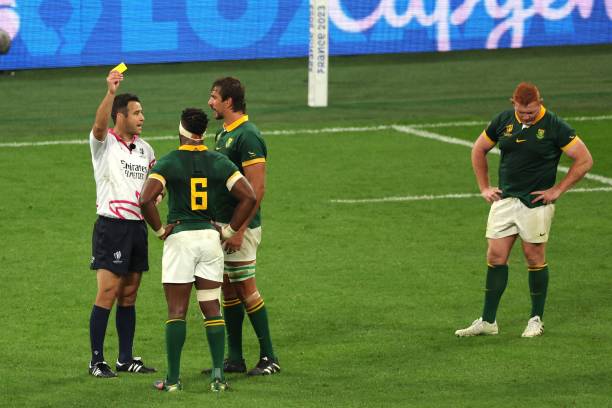 New Zealand referee Ben O'Keeffe delivers a yellow card to South Africa's lock Eben Etzebeth as South Africa's flanker and captain Siya Kolisi and...