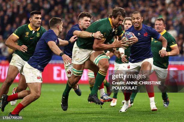 South Africa's lock Eben Etzebeth breaks through a tackle from France's fly-half Matthieu Jalibert and France's full-back Thomas Ramos to score South...