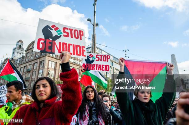 Protest holds a placard against genocide during a demonstration in solidarity with Palestine. The Palestinian community in Netherlands organized a...