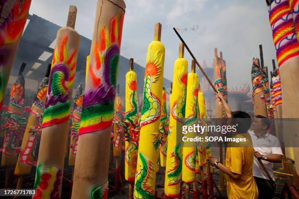 Devotees seen lighting giant incense sticks at the Ampang Nine Emperor Gods Temple. Nine Emperor Gods festival is celebrated on the ninth day of the...
