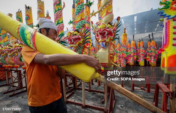 Temple worker is seen carrying the giant incense sticks at the Ampang Nine Emperor Gods Temple. Nine Emperor Gods festival is celebrated on the ninth...