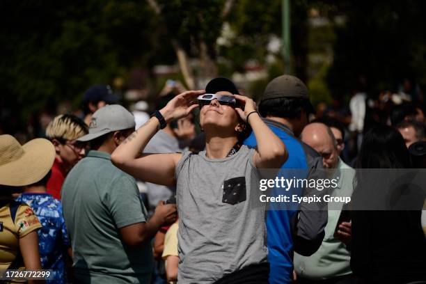 October 14 Mexico City, Mexico: A woman is seen watching the Annular Solar Eclipse with special sun filter glasses at the National Autonomous...