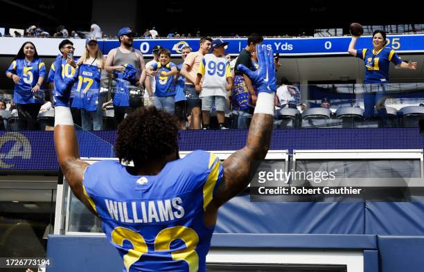 October 15: Los Angeles Rams Kyren Williams waves to a fan for the football before the game against the Arizona Cardinals at SoFi Stadium on Sunday,...