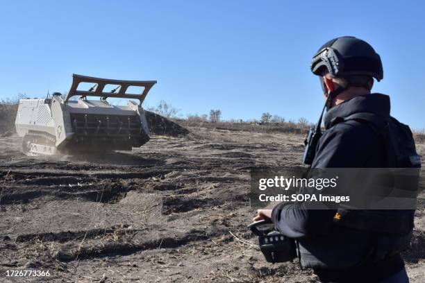 Ukrainian sapper operates the unmanned demining vehicle during the demining operation in Velyka Oleksandrivka. In March 2022, Velyka Oleksandrivka...