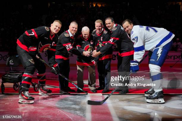 Former Ottawa Senators Chris Neil, Frank Finnigan Jr. Daniel Alfredsson and Chris Phillips of the Ottawa Senators drop the puck for a ceremonial...
