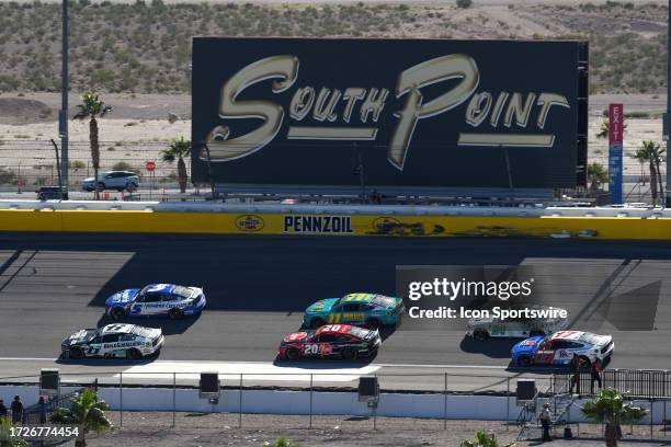 Brad Keselowski , Kyle Larson , Christopher Bell , Denny Hamlin , William Byron , and Chris Buescher drive under the South Point billboard during the...