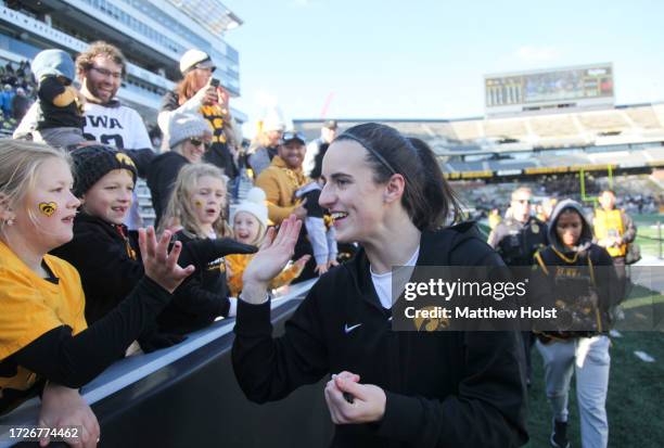 Guard Caitlin Clark of the Iowa Hawkeyes interacts with fans after the match-up against the DePaul Blue Demons at Kinnick Stadium during the...