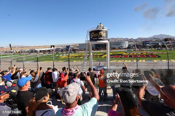 Fans use their smart phones to take pictures and video of Kyle Larson as he does a burnout after winning the NASCAR Cup Series Playoff South Point...