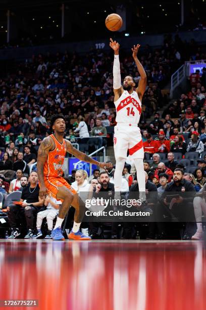 Garrett Temple of the Toronto Raptors puts up a shot over Elfrid Peyton of the Cairns Taipans during second half of an exhibition game at Scotiabank...