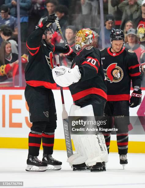 Zack MacEwen of the Ottawa Senators congratulates Joonas Korpisalo after his their 5-2 win against the Tampa Bay Lightning at Canadian Tire Centre on...
