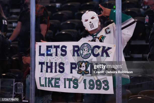 An Anaheim Ducks fan poses for a photo following a 6-3 win against the Carolina Hurricanes on October 15, 2023 at Honda Center in Anaheim, California.