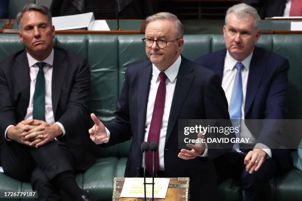 Australian Prime Minister Anthony Albanese reacts as he speaks during Question Time in the House of Representatives at Parliament House in Canberra...
