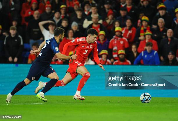 Wales' Neco Williams bursts past Croatia's Josip Stanisic during the UEFA EURO 2024 European qualifier match between Wales and Croatia at Cardiff...