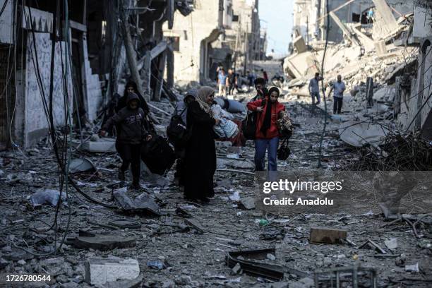 Palestinians carrying belongings flee to safer areas following Israeli bombardments on southern part of Gaza City, Tel al-Hawa neighborhood, Gaza on...