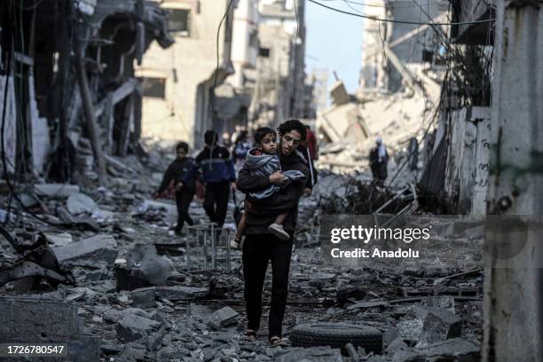 Palestinians carrying belongings flee to safer areas following Israeli bombardments on southern part of Gaza City, Tel al-Hawa neighborhood, Gaza on...