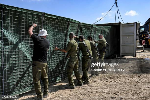 Members of the Israeli army build a bomb shelter for residents of the Arara Bedouin community in the Negev Desert on October 14, 2023. In Israel's...