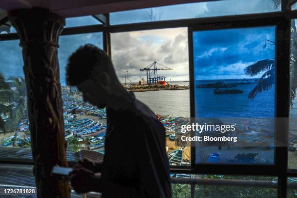 Gantry crane and the Zhen Hua 15 heavy load cargo carrier at the Vizhinjam transshipment container port, developed by Adani Ports and Special...