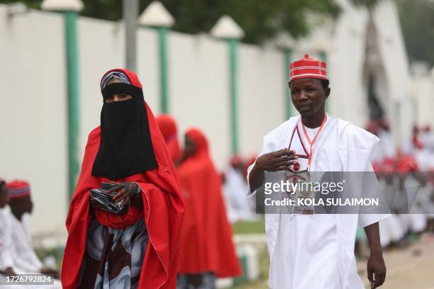Couple arrives at the venue of a wedding reception at the Kano state governor's office after taking part in a mass wedding at the central mosque iin...
