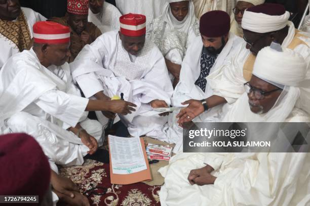 Families and Government officials sits inside the Kano Central Mosque to conclude the Islamic rites of solemnisation of the wedding of 1800 couples...