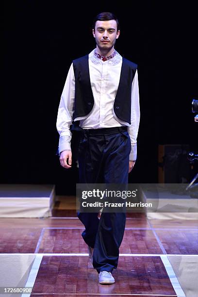 Model walks the runway at the Hochschule Pforzheim Show during Mercedes-Benz Fashion Week Spring/Summer 2014 at Landesvertretung Baden-Wuerttemberg...