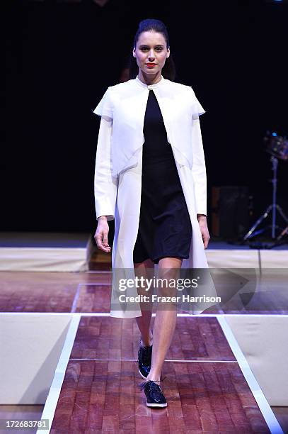 Model walks the runway at the Hochschule Pforzheim Show during Mercedes-Benz Fashion Week Spring/Summer 2014 at Landesvertretung Baden-Wuerttemberg...