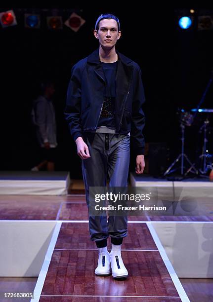 Model walks the runway at the Hochschule Pforzheim Show during Mercedes-Benz Fashion Week Spring/Summer 2014 at Landesvertretung Baden-Wuerttemberg...