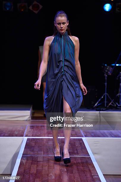 Model walks the runway at the Hochschule Pforzheim Show during Mercedes-Benz Fashion Week Spring/Summer 2014 at Landesvertretung Baden-Wuerttemberg...