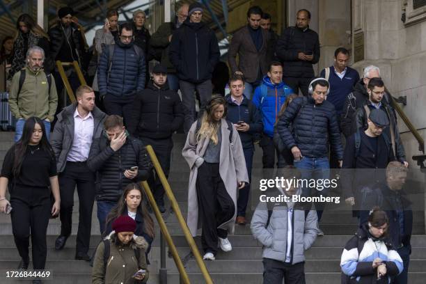 Commuters exit London Waterloo railway station in London, UK, on Monday, Oct. 16, 2023. Changing attitudes to work since the pandemic and sluggish...