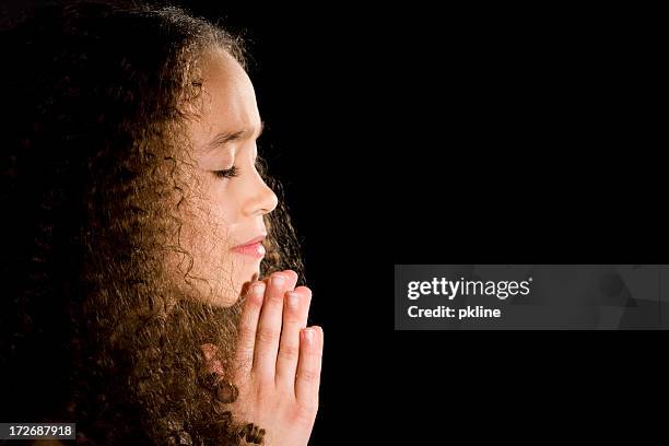 side view of little girl in prayer - child praying stock pictures, royalty-free photos & images