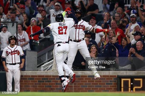 Austin Riley celebrates with Marcell Ozuna Atlanta Braves after hitting a two-run home run in the eighth inning against the Philadelphia Phillies...