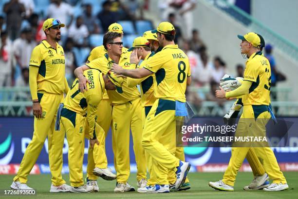 Australia's David Warner celebrates with teammates after taking the catch of Sri Lanka's Kusal Mendis during the 2023 ICC Men's Cricket World Cup...