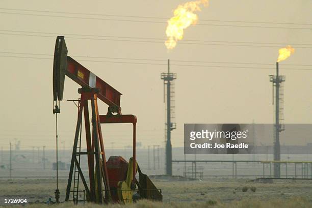Derek pumps in a oil field January 15, 2003 near the Saudi Arabian border, Kuwait. Kuwait produces 10% of the worlds oil and has promised to increase...