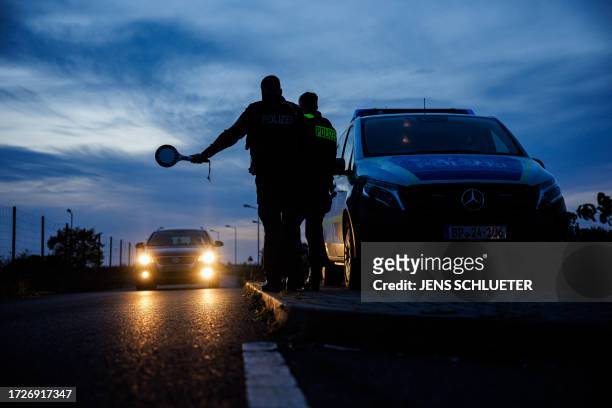 Officers of the German Federal Police stop a car near Forst, eastern Germany on October 11 during a patrol near the border with Poland.