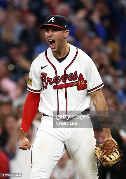 Matt Olson of the Atlanta Braves reacts to a double play that ended the game against the Philadelphia Phillies to win Game Two of the Division Series...