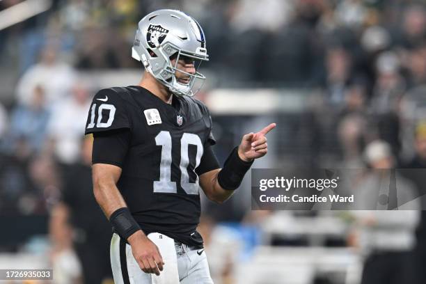 Jimmy Garoppolo of the Las Vegas Raiders celebrates after thrown a pass for a touchdown during the second quarter against the Green Bay Packers at...