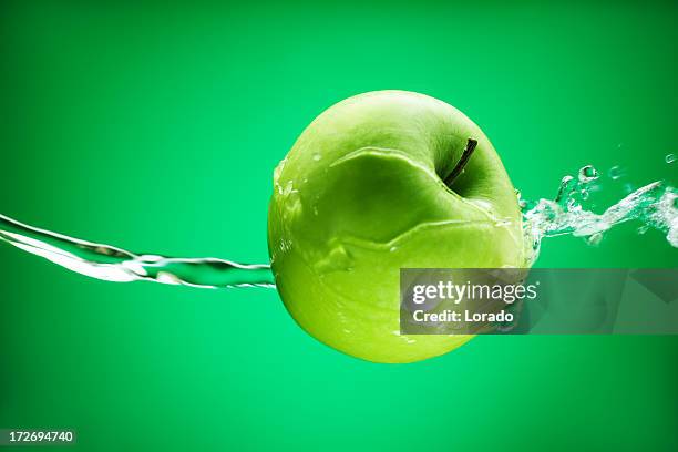 apple in water - apple water splashing stock pictures, royalty-free photos & images