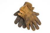 Old well worn leather work gloves-isolated on white