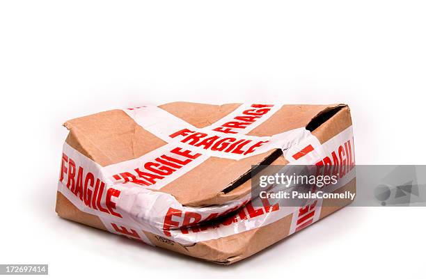 a smashed box with fragile tape all around it - fragility stock pictures, royalty-free photos & images