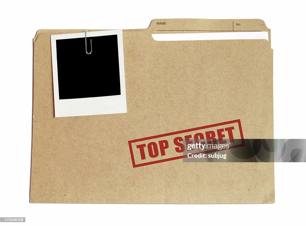 Top secret file in a folder with a Polaroid attached