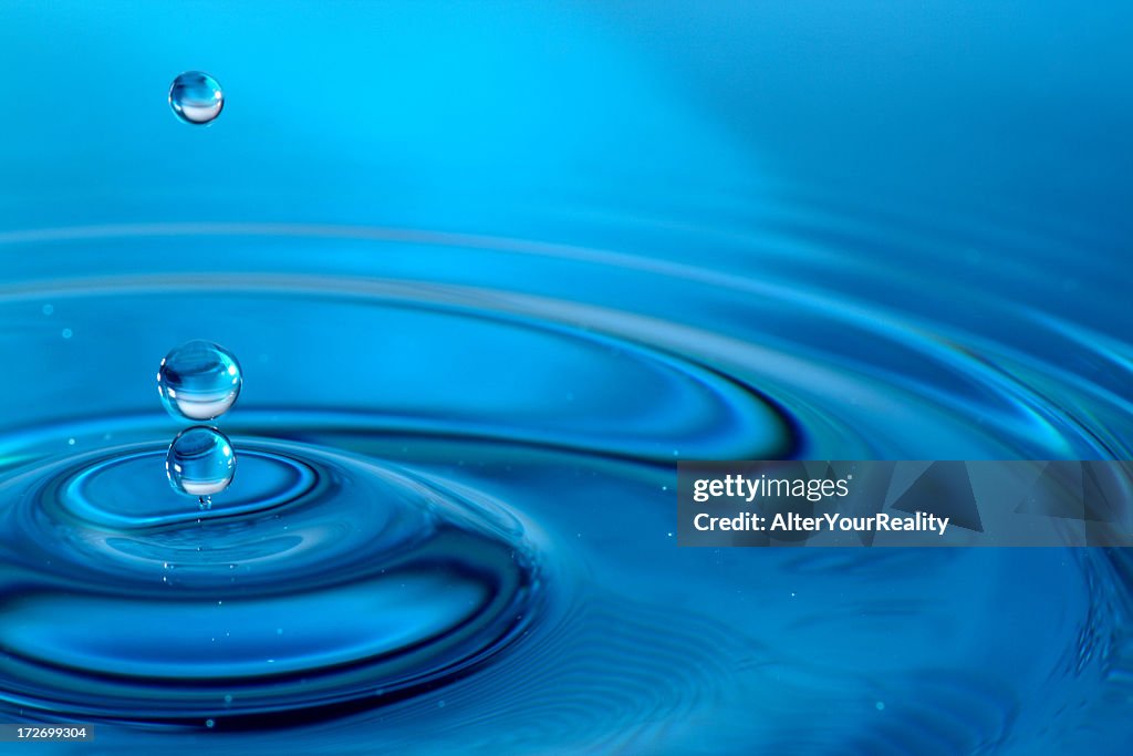 Droplets Of Water Falling Into A Puddle High-Res Stock Photo - Getty Images