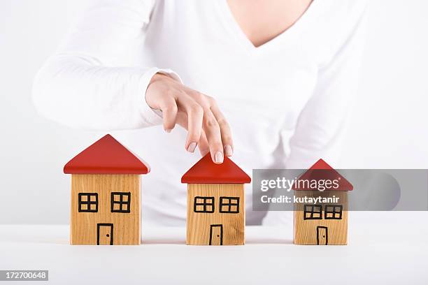 house series - woman picking up toys stock pictures, royalty-free photos & images