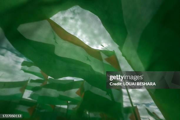 Demonstrators unfurl the Palestinian and Syrian flag during an anti-Israel rally in solidarity with the Palestinian people in Damascus' Abbasyyn...