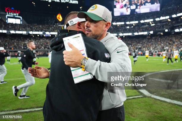 Head coach Josh McDaniels of the Las Vegas Raiders and Head coach Matt LaFleur of the Green Bay Packers hug following the game at Allegiant Stadium...