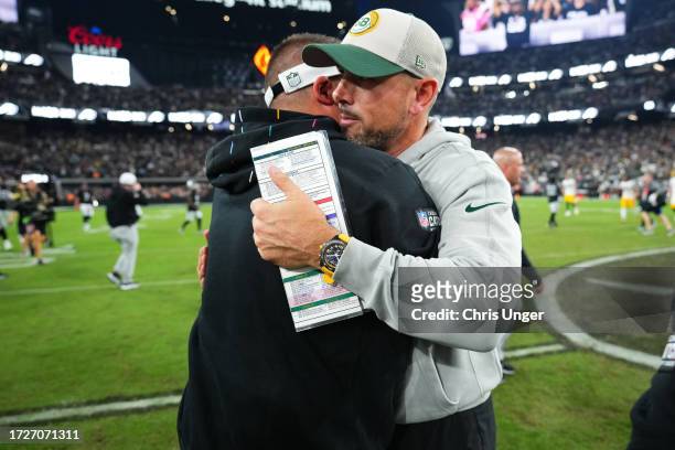 Head coach Josh McDaniels of the Las Vegas Raiders and Head coach Matt LaFleur of the Green Bay Packers hug following the game at Allegiant Stadium...