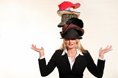 Business woman balancing life having to wear too many hats
