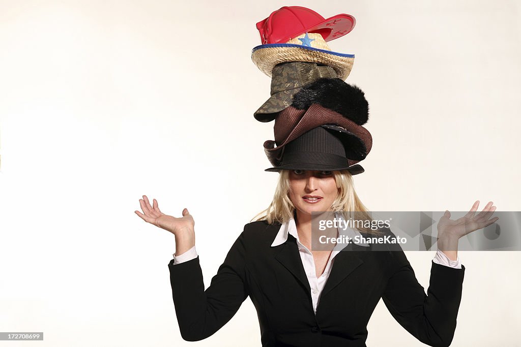 Business woman balancing life having to wear too many hats