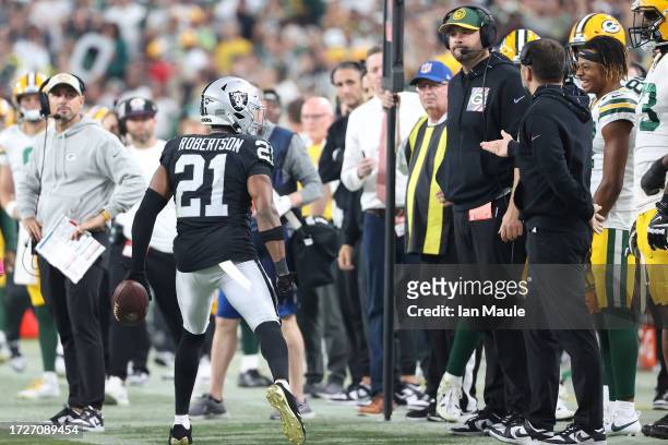 Head coach Matt LaFleur of the Green Bay Packers looks on as Amik Robertson of the Las Vegas Raiders celebrates after intercepting the ball during...
