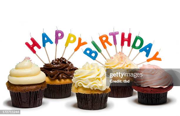 five differently iced cupcakes with birthday candles on them - birthday cake white background stock pictures, royalty-free photos & images
