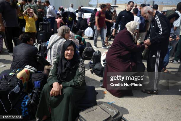 Palestinians, some with foreign passports hoping to cross into Egypt and others waiting for aid wait at the Rafah crossing in the southern Gaza...
